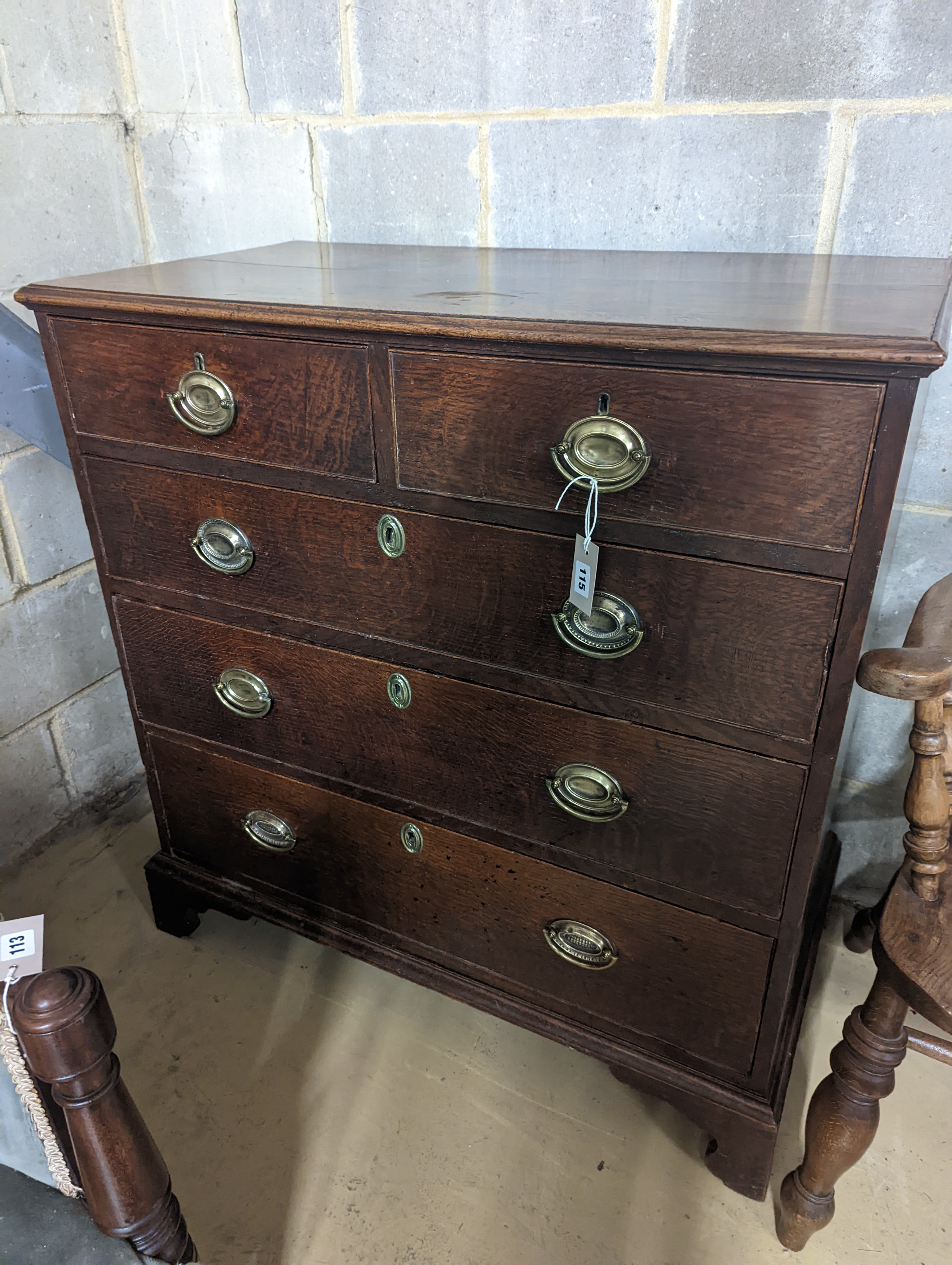 A George III oak chest of two short and three long graduated drawers, . W-94cm, D-51cm, H-99cm.